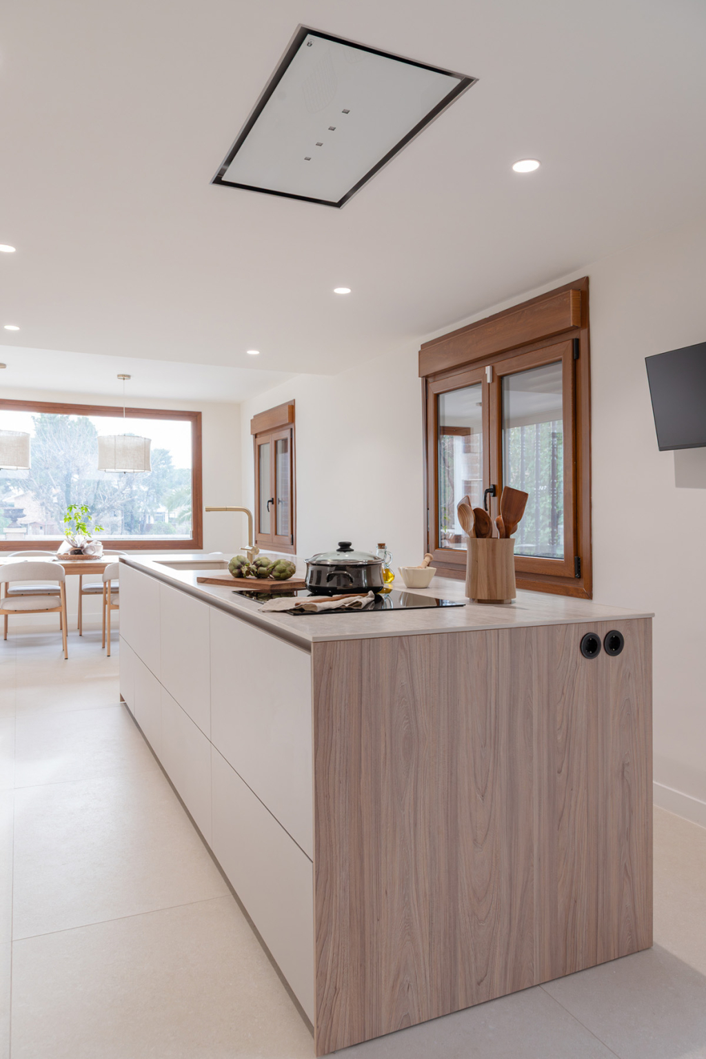 Isla en una cocina Cashmere abierta al comedor diseñada por la tienda de cocinas en Madrid Santos Vaguada.