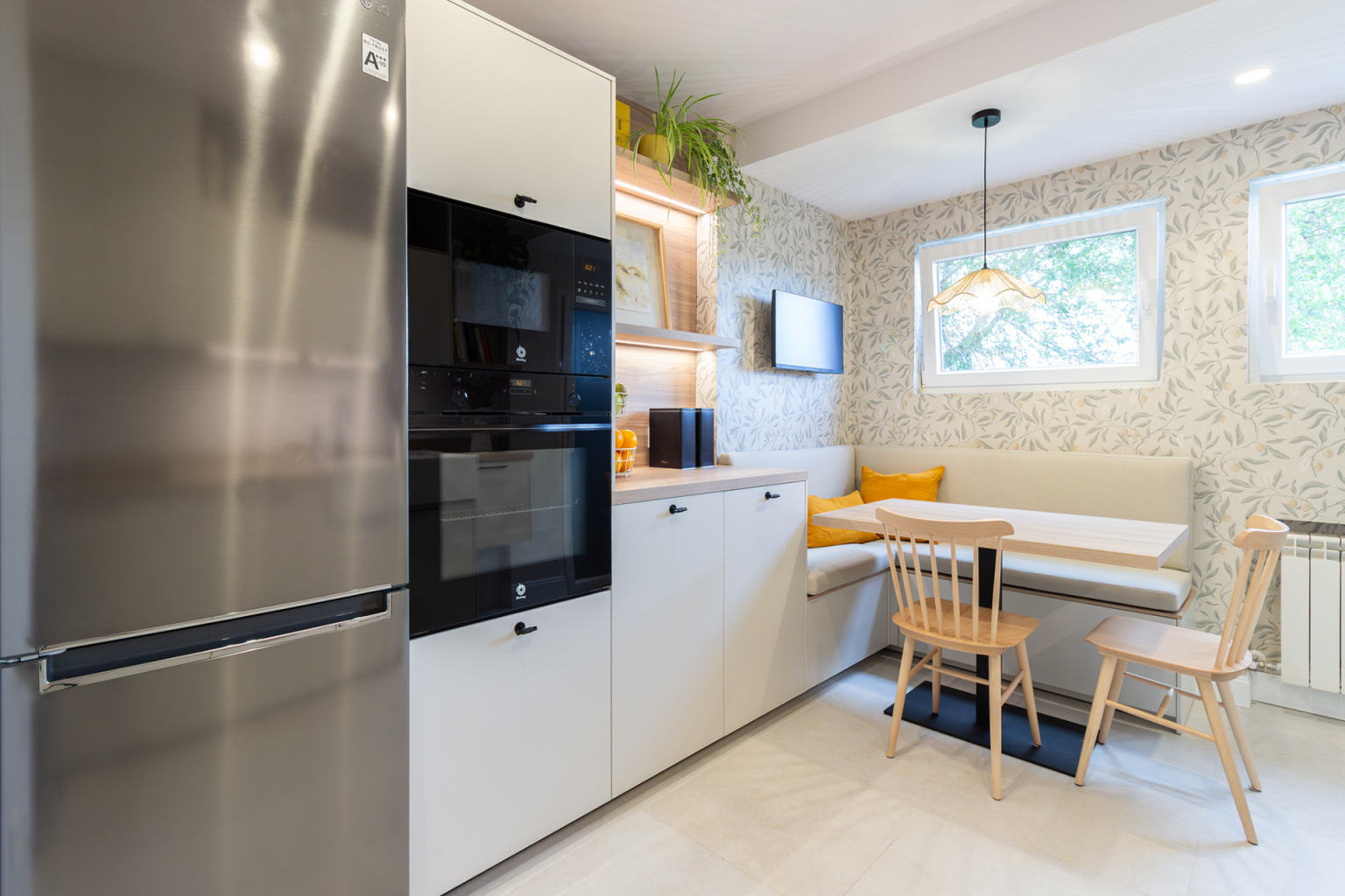 Cocina con office y desayunador con acabados en madera diseñada por el estudio de cocinas en Madrid Santos Vaguada.